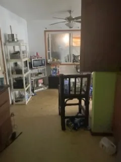 a bedroom with furniture and a large window