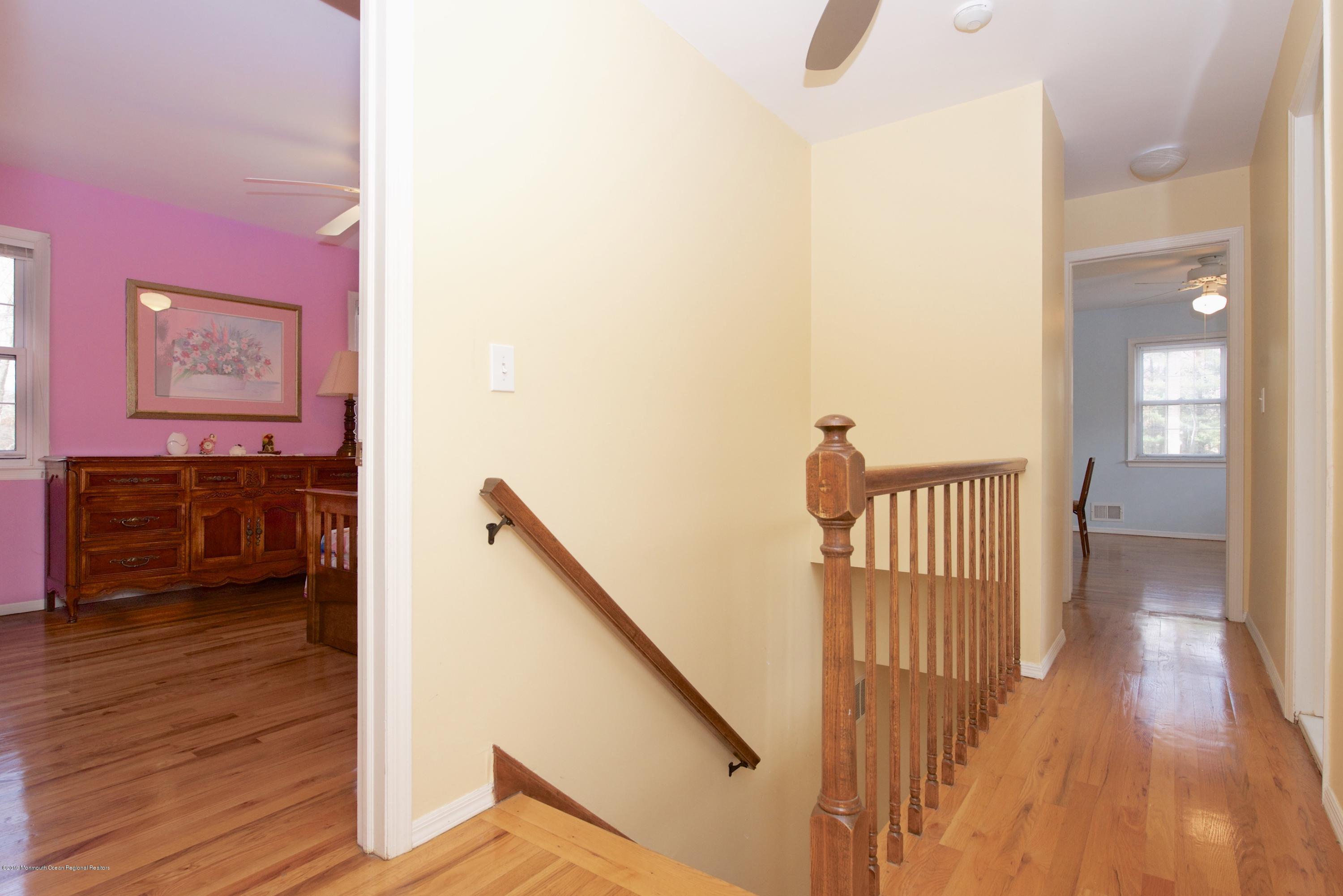 131 Millstone Road Millstone Township, NJ 08535 - Photo 14 of 27 a view of a hallway with wooden floor and stairs