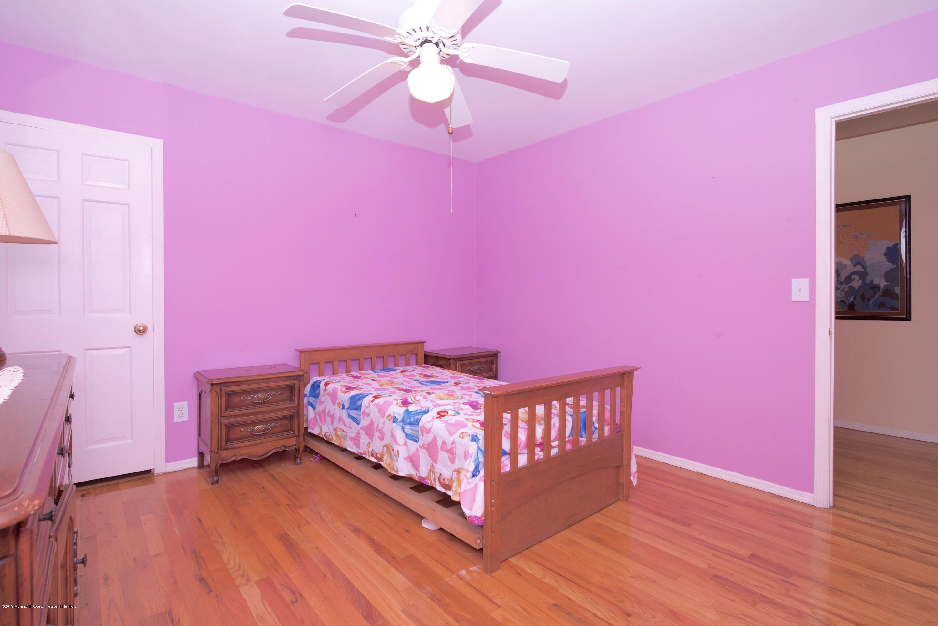 131 Millstone Road Millstone Township, NJ 08535 - Photo 18 of 27 a bedroom with pink walls a pink bed and pink walls