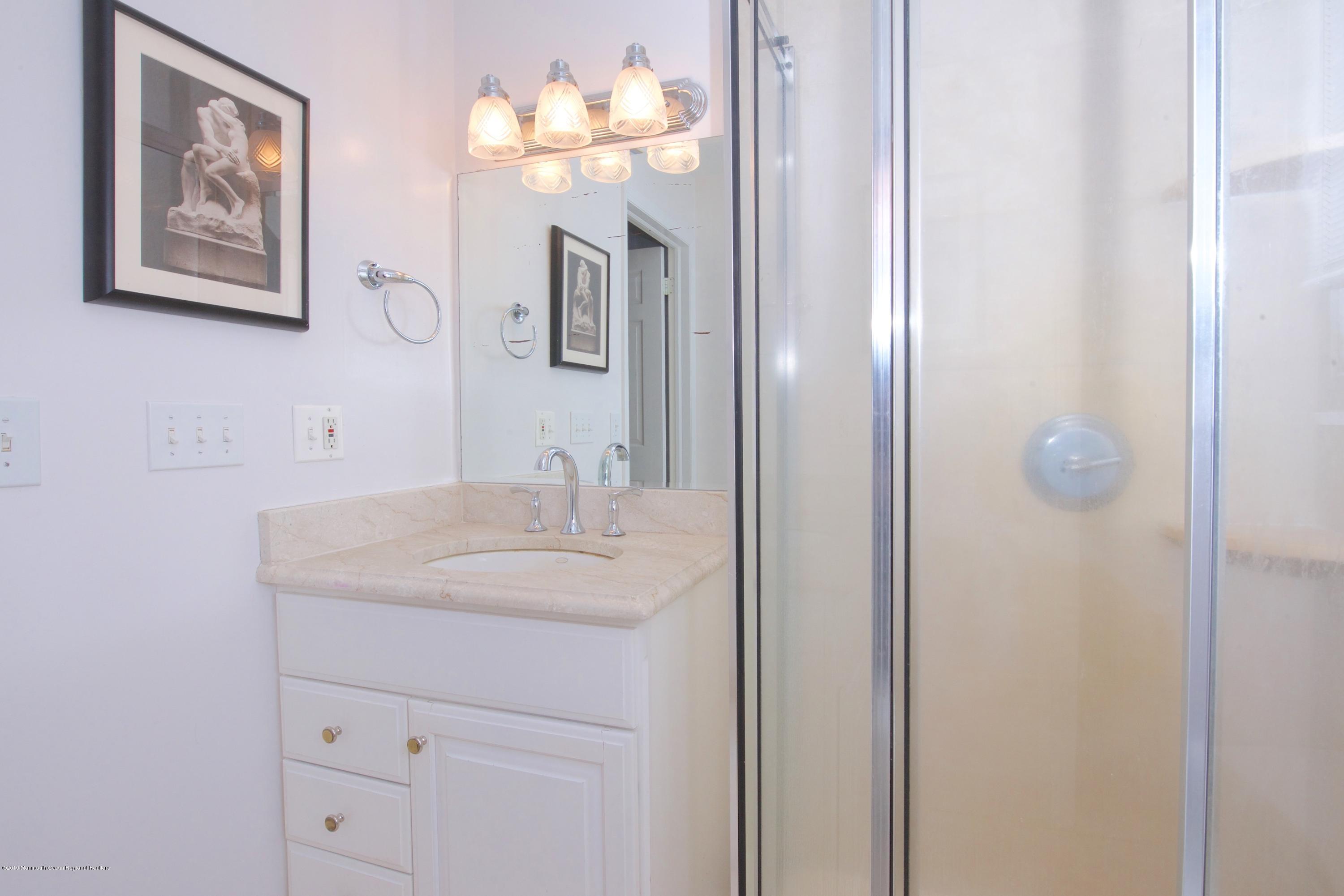 131 Millstone Road Millstone Township, NJ 08535 - Photo 20 of 27 a bathroom with a sink vanity and a mirror