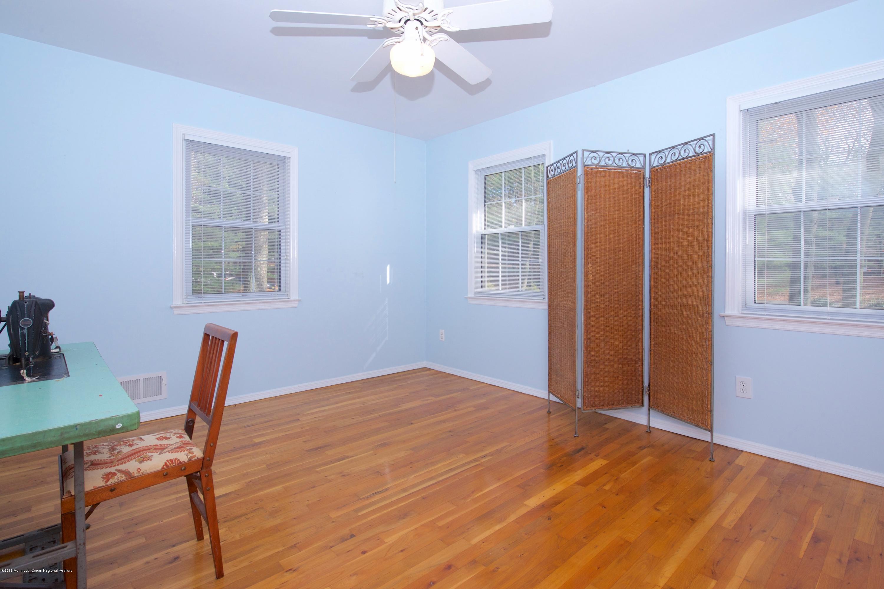 131 Millstone Road Millstone Township, NJ 08535 - Photo 21 of 27 a view of a room with furniture wooden floor and chandelier