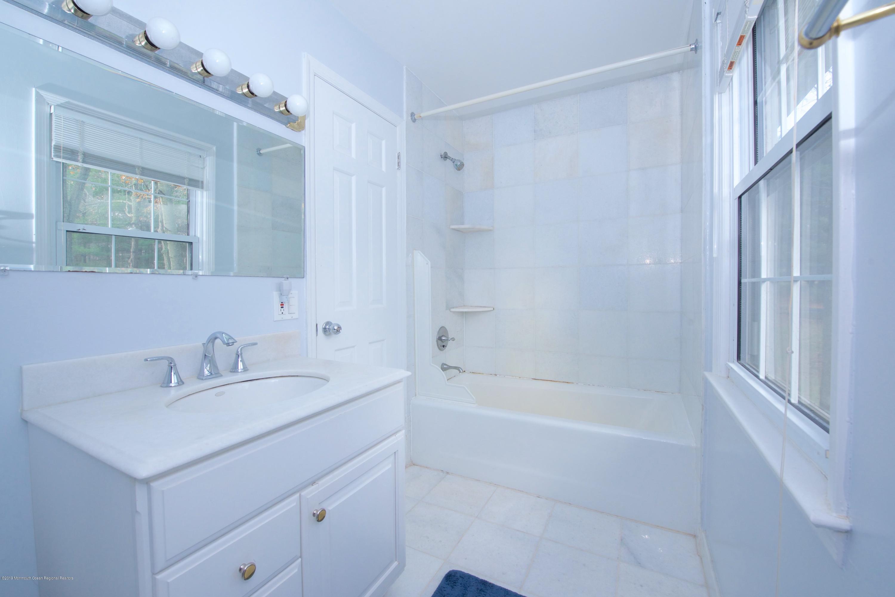 131 Millstone Road Millstone Township, NJ 08535 - Photo 23 of 27 a white bath tub sitting next to a white sink