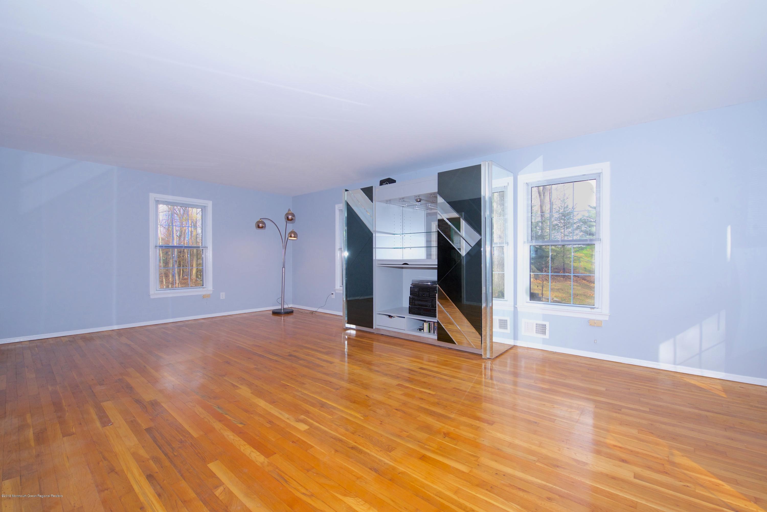 131 Millstone Road Millstone Township, NJ 08535 - Photo 4 of 27 a view of empty room with wooden floor and fan