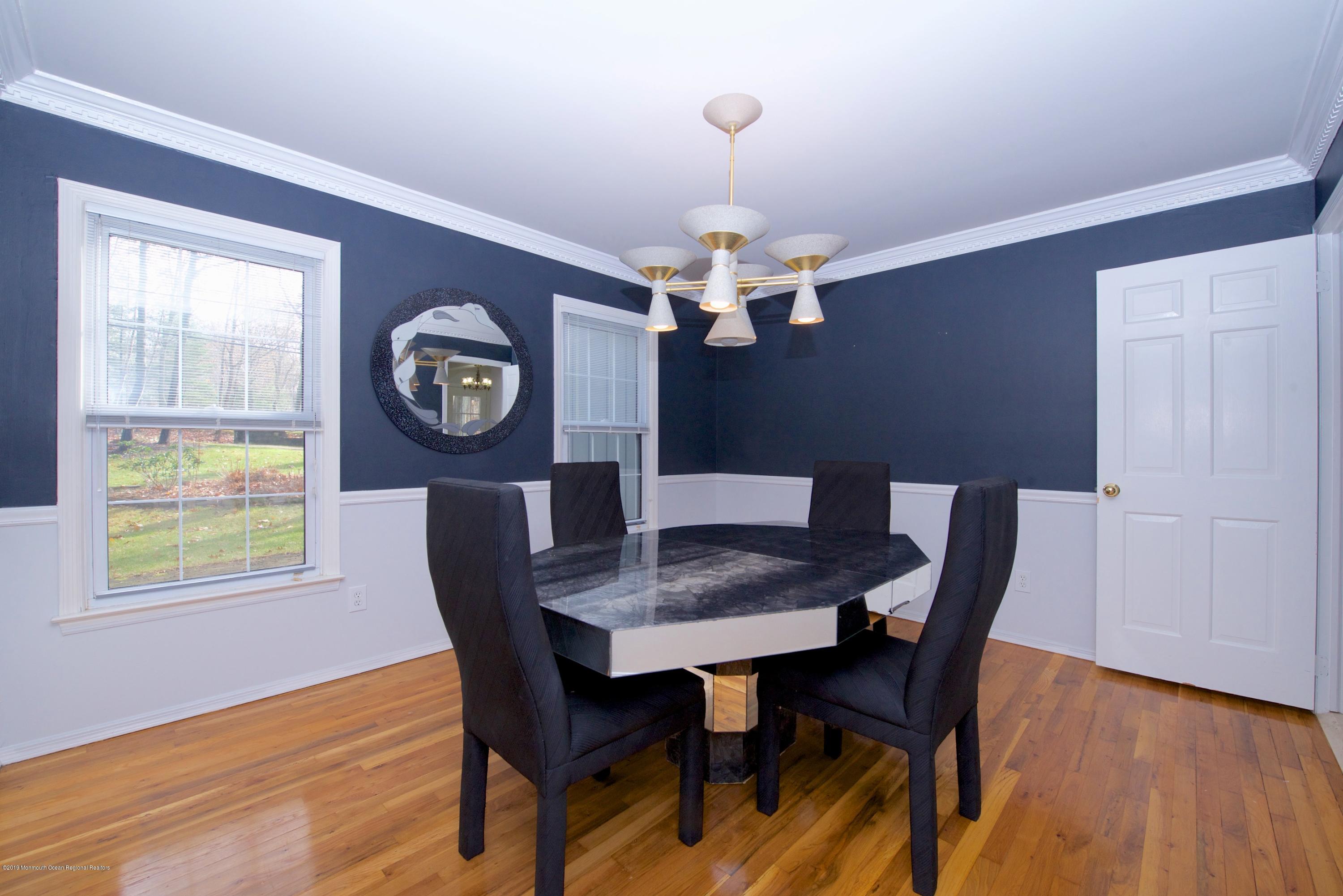 131 Millstone Road Millstone Township, NJ 08535 - Photo 6 of 27 a view of a dining room with furniture a chandelier and wooden floor