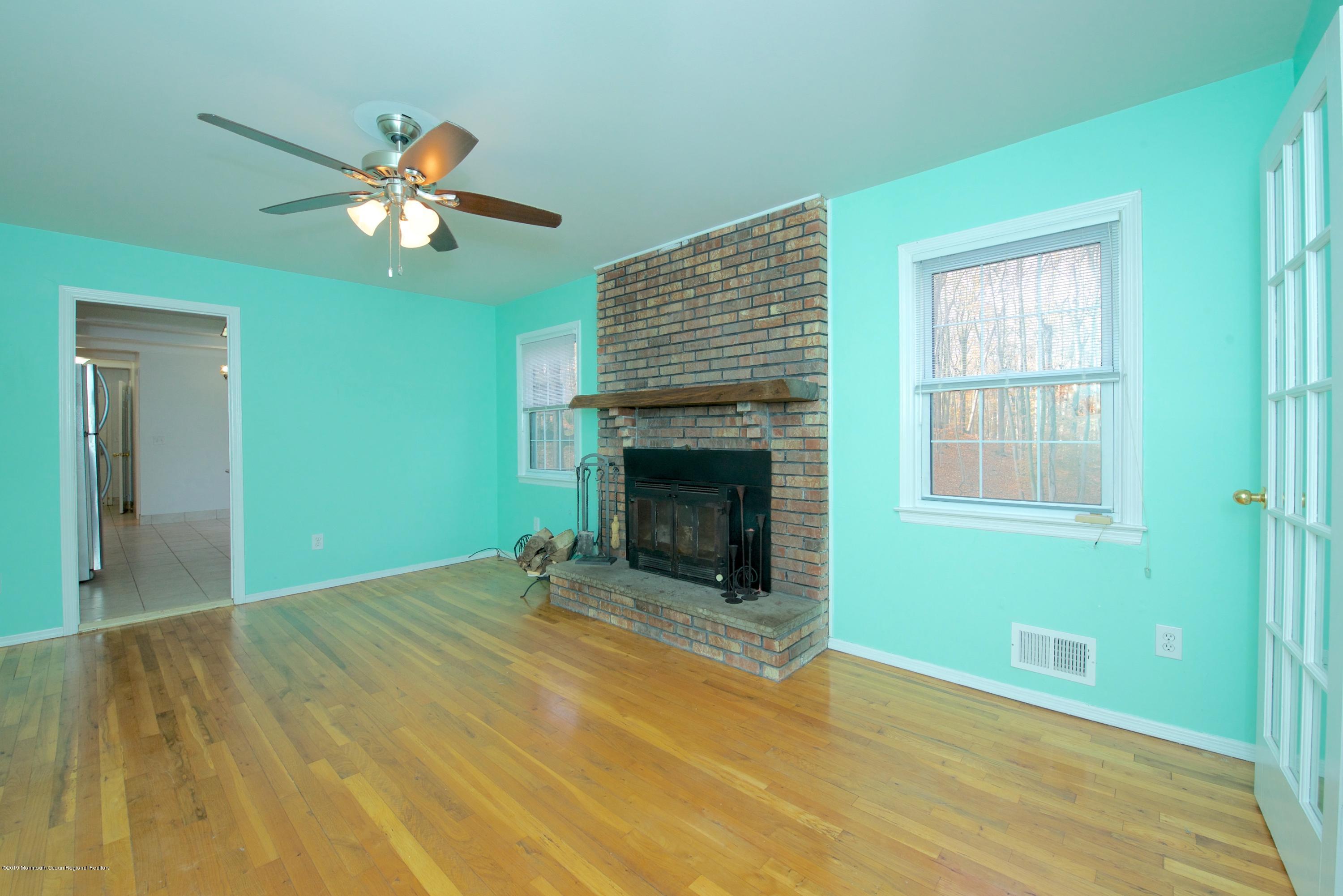 131 Millstone Road Millstone Township, NJ 08535 - Photo 9 of 27 a view of an empty room with a fireplace and a window