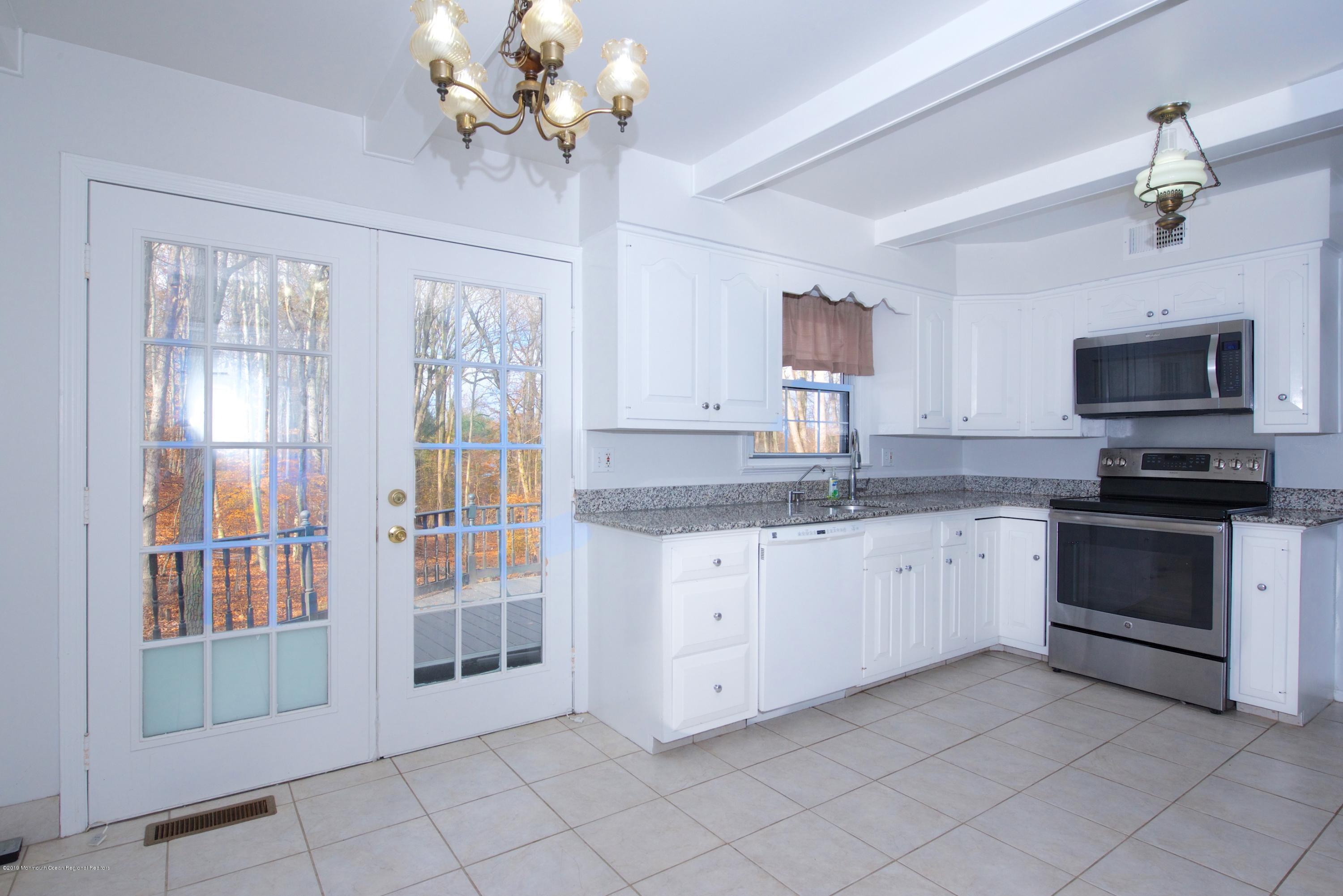 131 Millstone Road Millstone Township, NJ 08535 - Photo 10 of 27 a kitchen with a stove sink and microwave