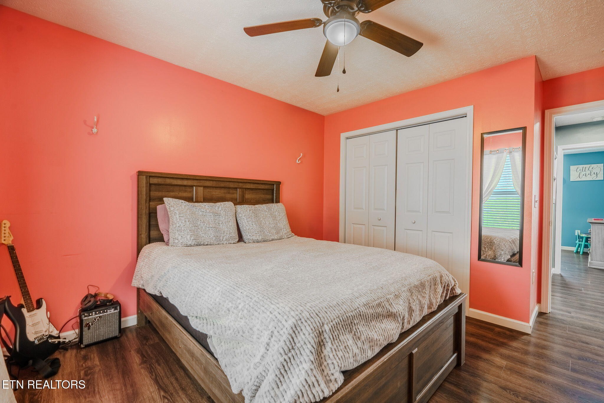 3215 Smith Road White Pine, TN 37890 - Photo 17 of 28 a bedroom with a bed and wooden floor