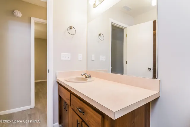 a bathroom with a sink vanity and a mirror