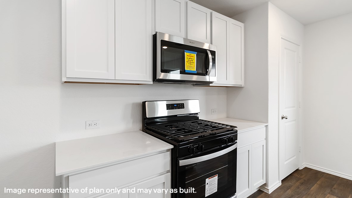 136 Wyatt Way Jarrell, TX 76537 - Photo 4 of 26 a kitchen with white cabinets and black appliances