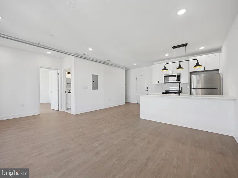 1614-20 Ridge Avenue, Unit 504 Philadelphia, PA 19130 - Photo 11 of 17 a large white room with kitchen area and natural light