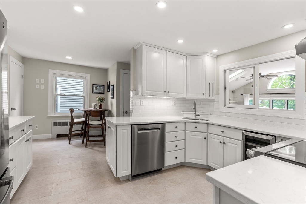 48 Spring Street Wakefield, MA 01880 - Photo 9 of 28 a kitchen that has a sink a table and chairs in it