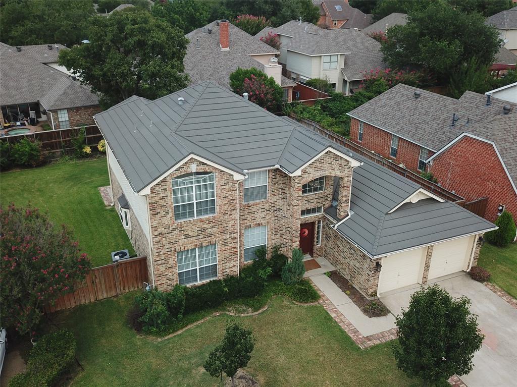 an aerial view of a house with a yard