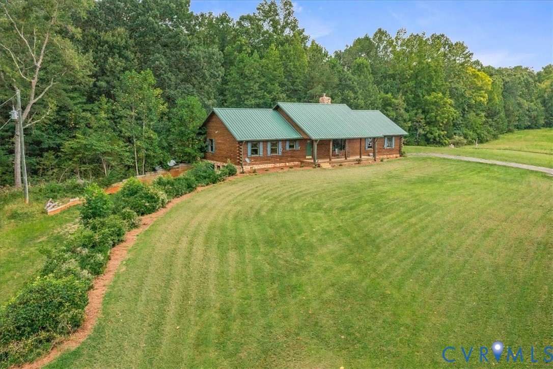 a view of a house with pool and a yard