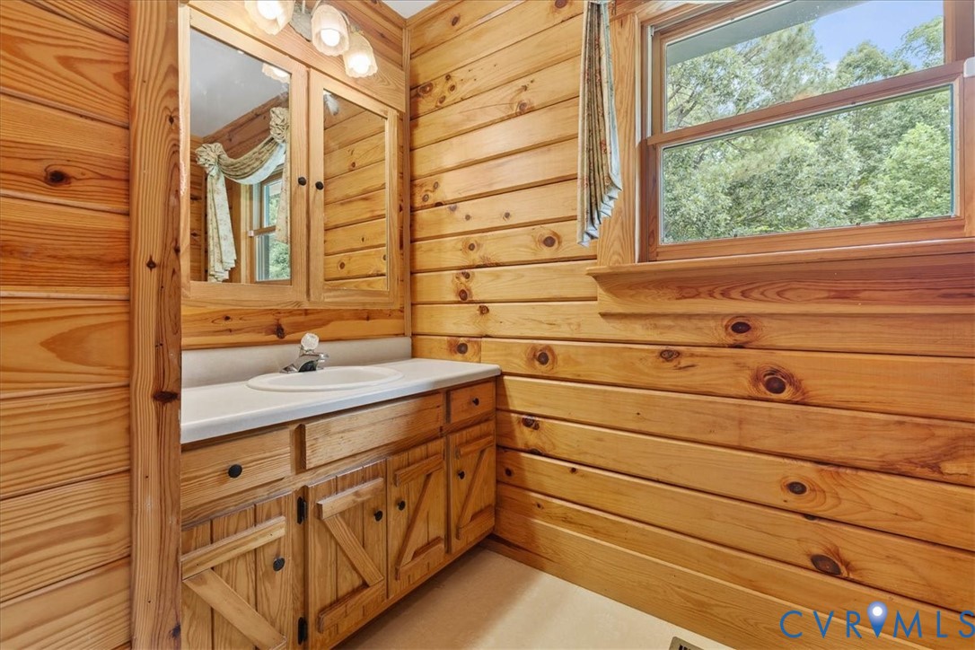 18901 Shippings Road Dewitt, VA 23840 - Photo 25 of 50 a bathroom with a double vanity sink a mirror and a bathtub