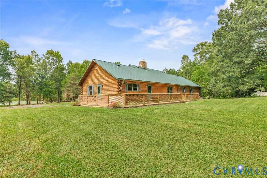 18901 Shippings Road Dewitt, VA 23840 - Photo 35 of 50 a house view with garden space and trees in the background