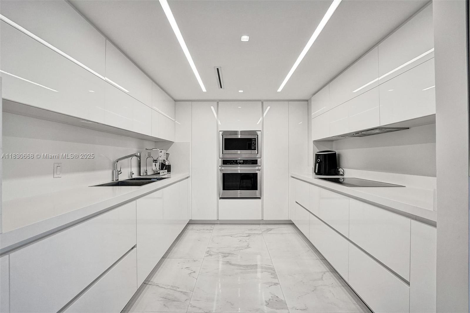 2 Grove Isle Drive, Unit B410 Miami, FL 33133 - Photo 13 of 43 a kitchen with stainless steel appliances a refrigerator sink and stove