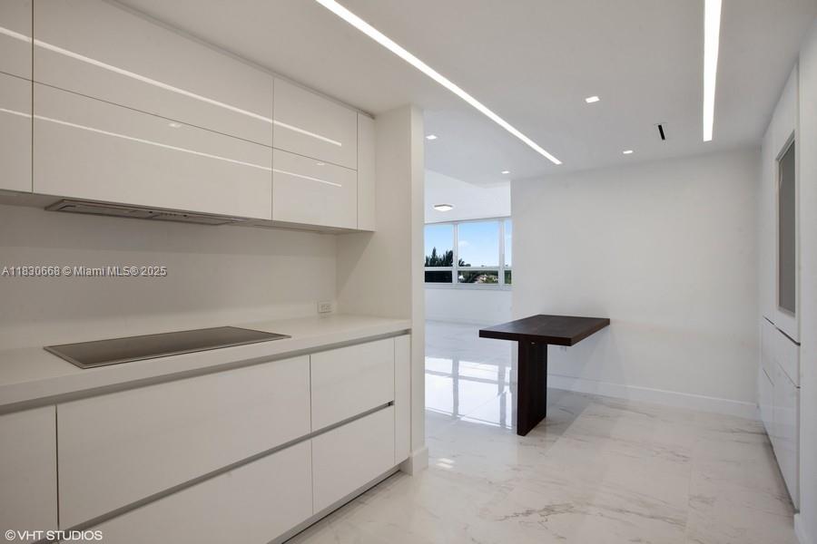 2 Grove Isle Drive, Unit B410 Miami, FL 33133 - Photo 15 of 43 a kitchen with a sink and a refrigerator