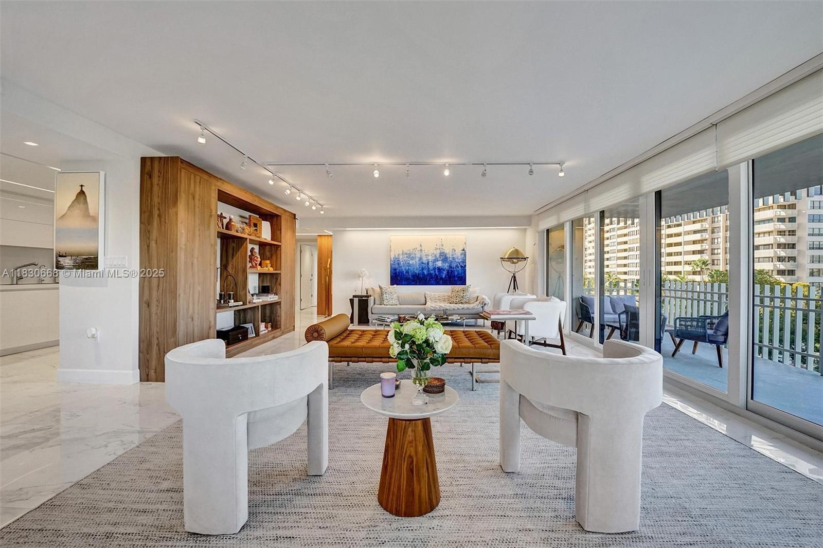 2 Grove Isle Drive, Unit B410 Miami, FL 33133 - Photo 19 of 43 a living room with fireplace furniture and a large window