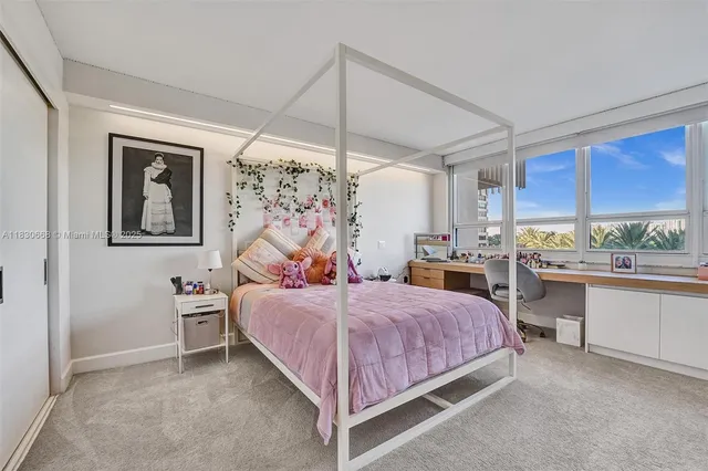 a bathroom with a sink and mirror with shower