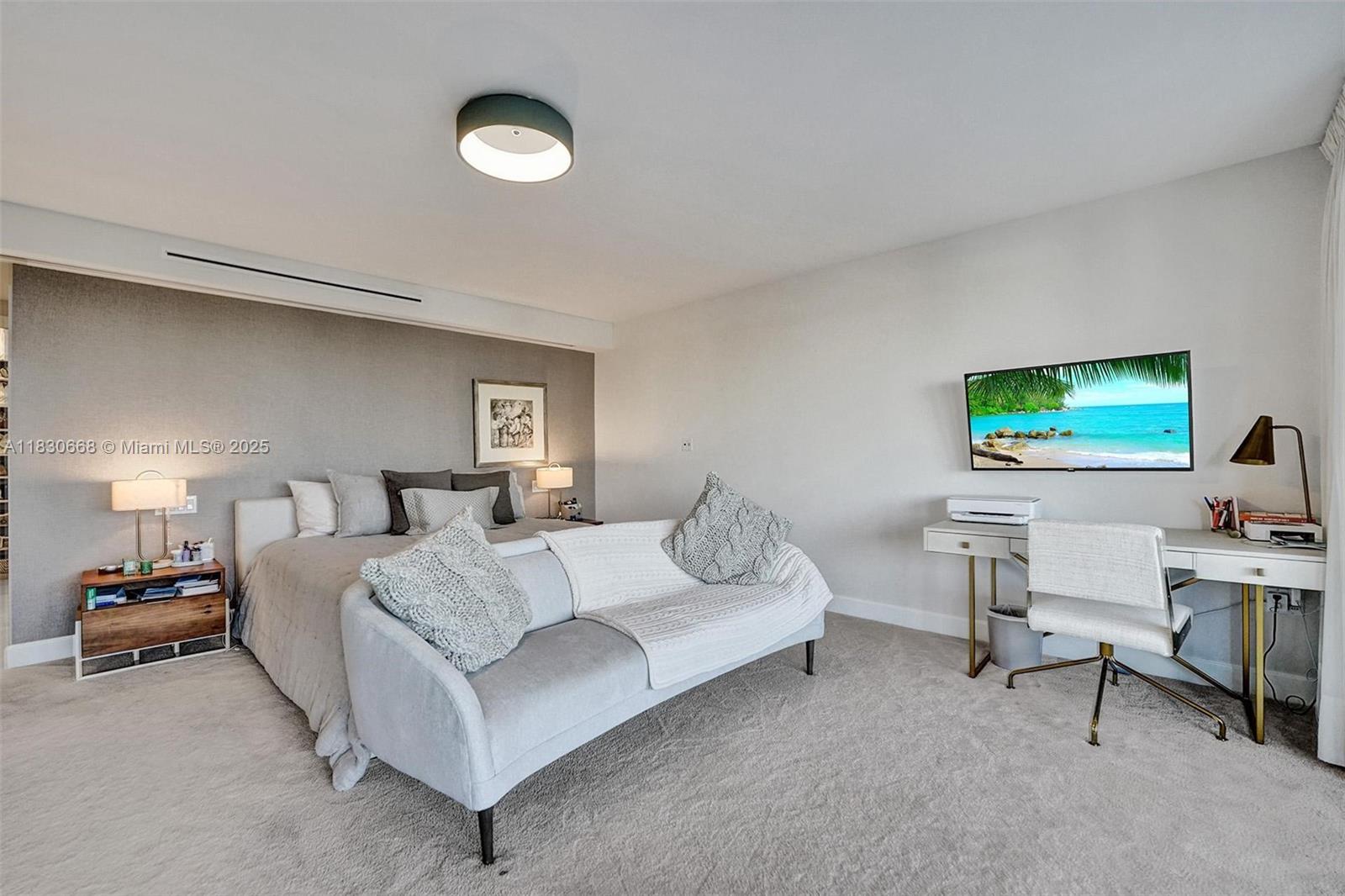 2 Grove Isle Drive, Unit B410 Miami, FL 33133 - Photo 34 of 43 a bedroom with a bed and a flat screen tv