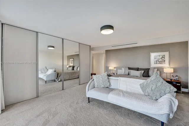 a living room with a couch and a potted plant