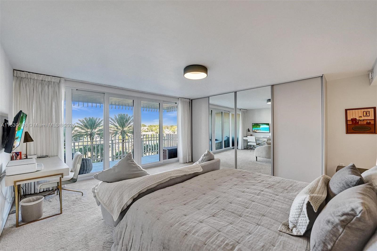 2 Grove Isle Drive, Unit B410 Miami, FL 33133 - Photo 36 of 43 a bedroom with a bed and a large window