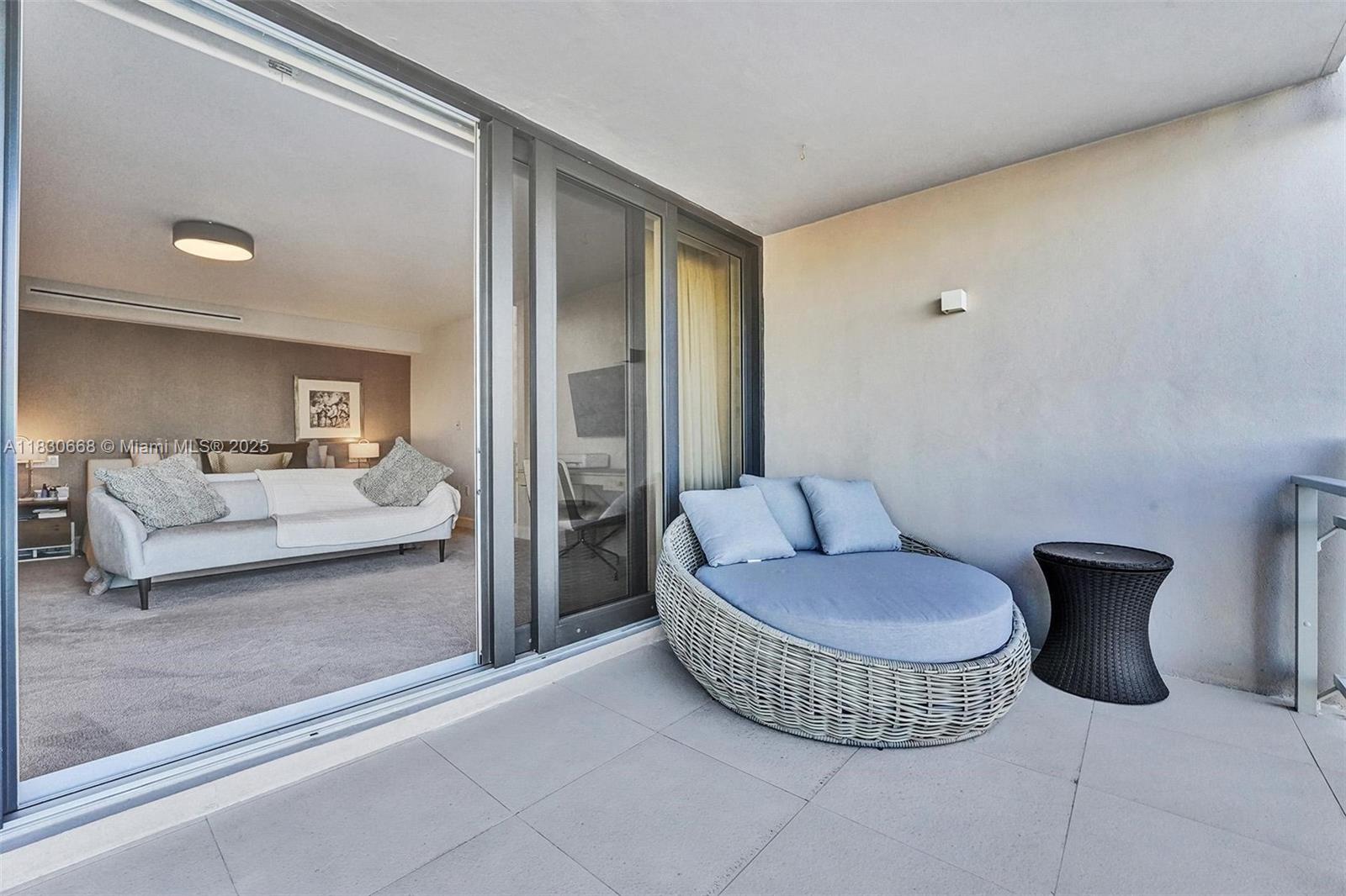 2 Grove Isle Drive, Unit B410 Miami, FL 33133 - Photo 38 of 43 a living room with a couch and a potted plant