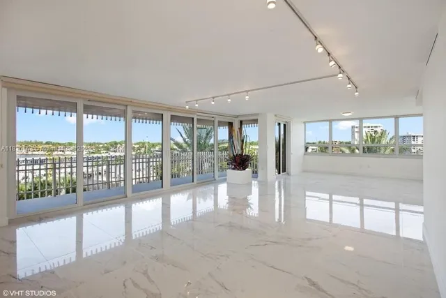 a living room with furniture fireplace and a large window