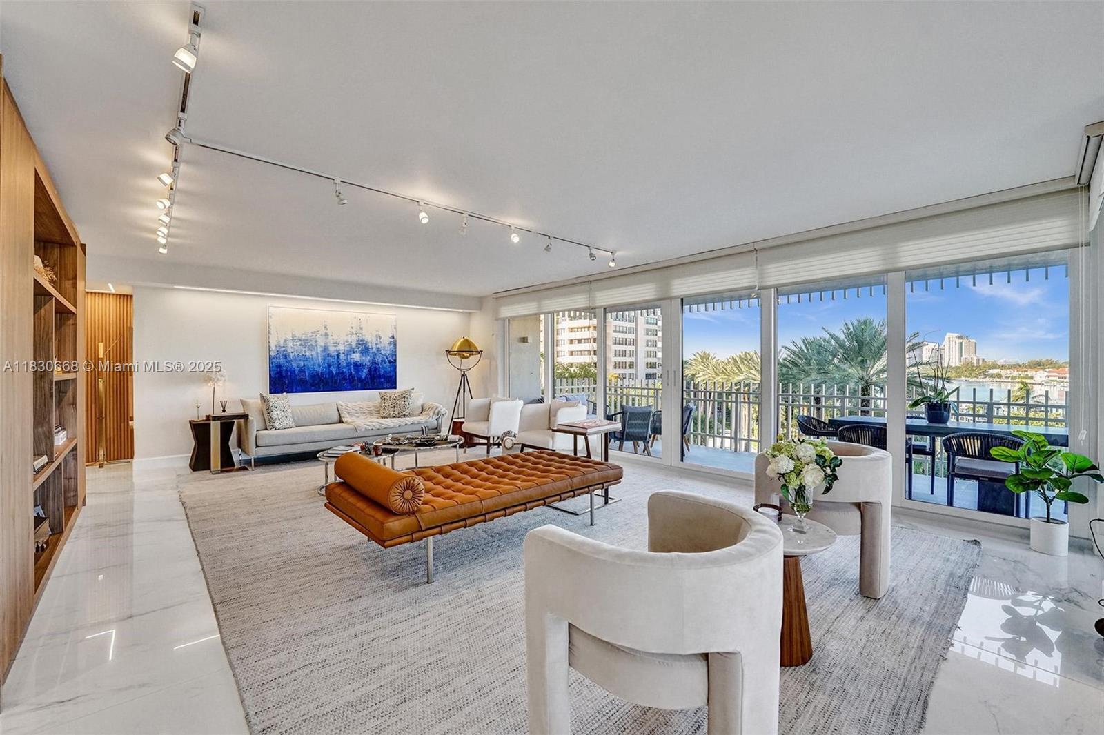 2 Grove Isle Drive, Unit B410 Miami, FL 33133 - Photo 6 of 43 a living room with furniture fireplace and a large window