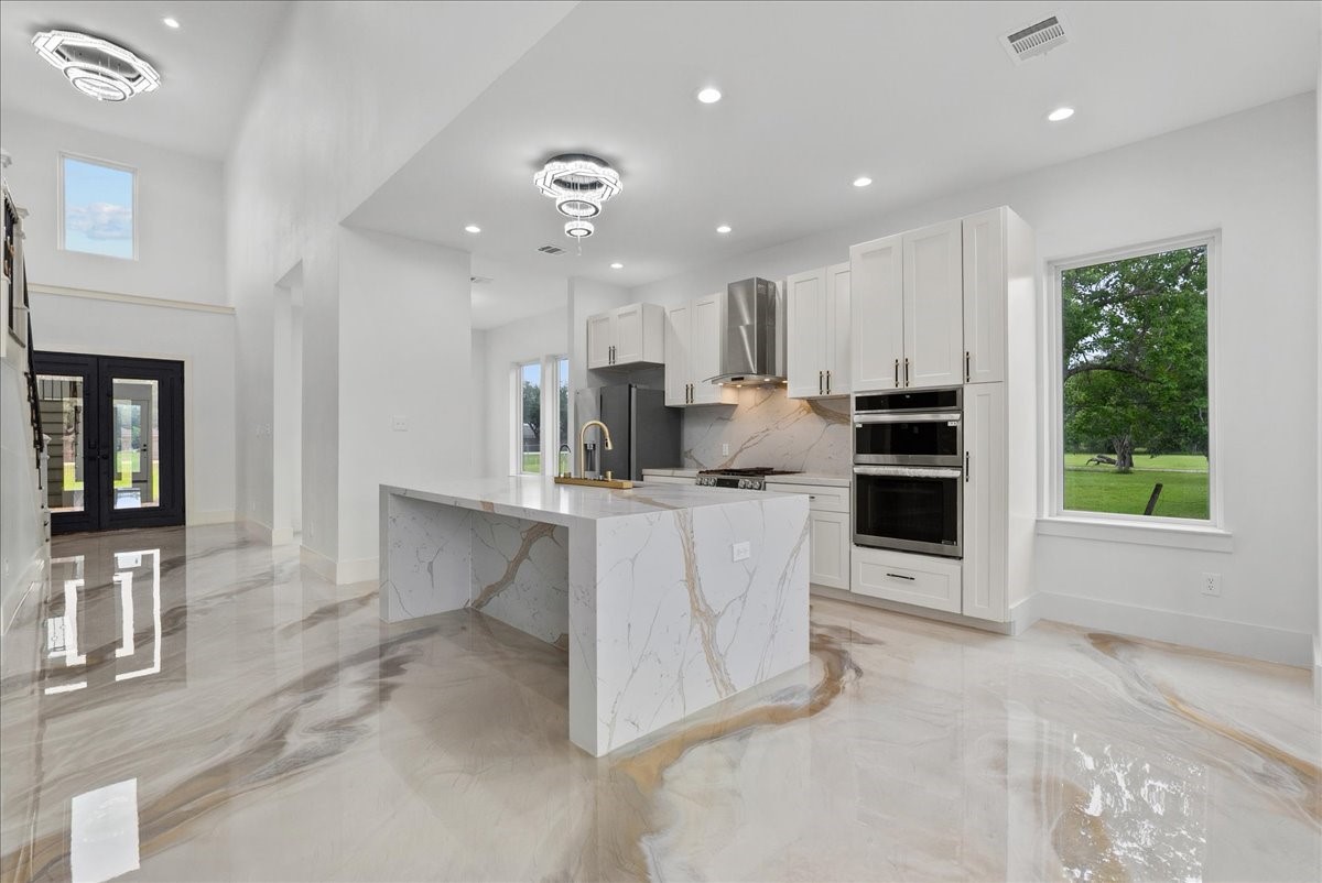 3237 Harkey Road Pearland, TX 77584 - Photo 15 of 46 Designer kitchen with double ovens and modern cabinetry.