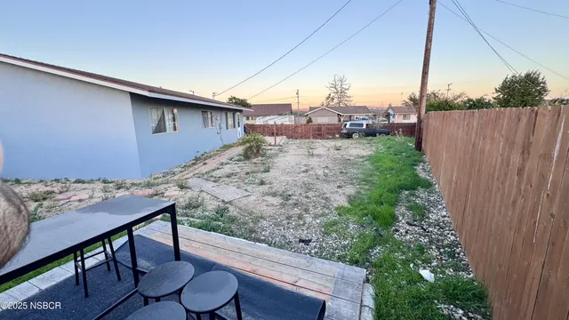 a view of a backyard with plants and outdoor seating