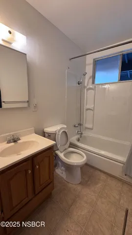 a bathroom with a double vanity sink toilet and shower