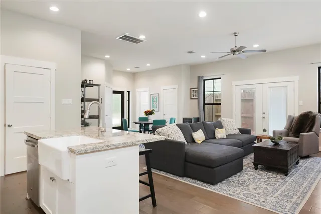 a living room with furniture and a chandelier