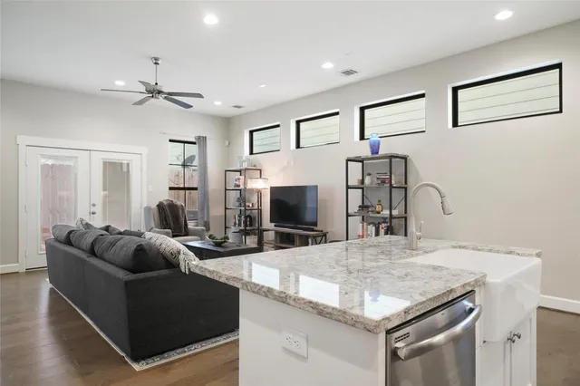 a living room with furniture wooden floor and a rug