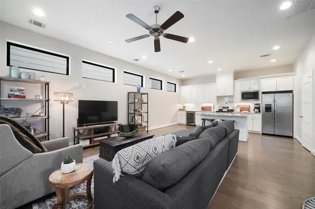 a living room with furniture and kitchen view
