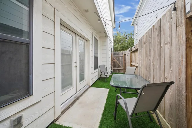 a spacious bedroom with a bed a dresser and a large window
