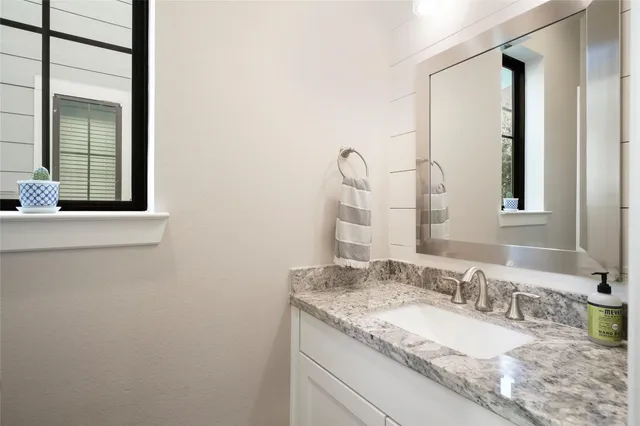 a bedroom with a bed dresser and a ceiling fan