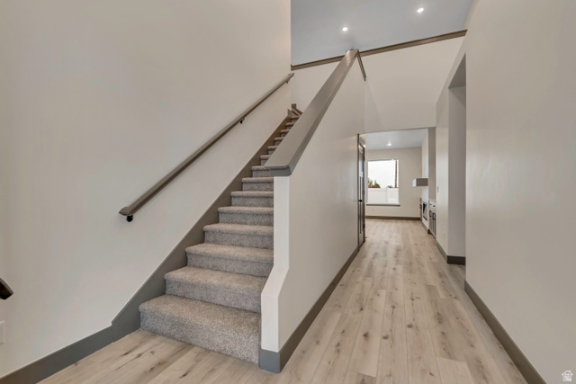 3317 South 1000 West, Unit 6010 Logan, UT 84321 - Photo 12 of 34 Staircase with wood finished floors and recessed lighting