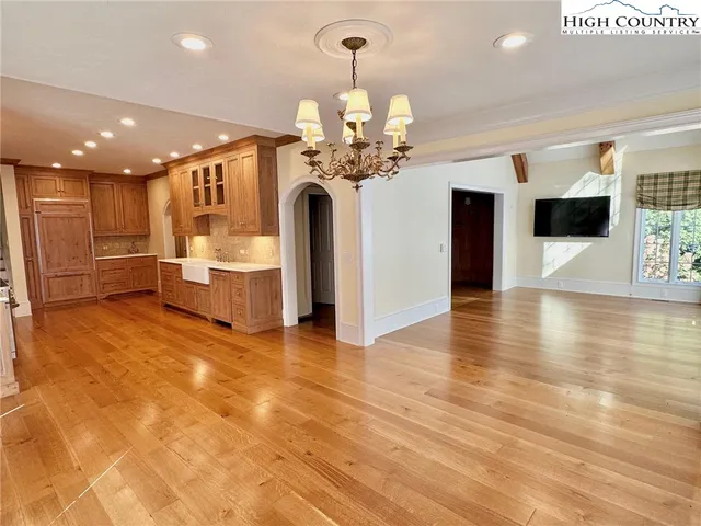 a view of a living room a chandelier and fireplace