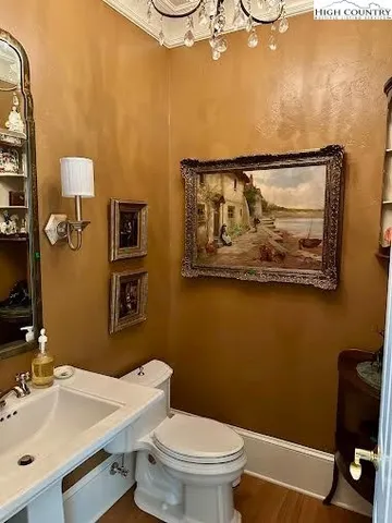 a bathroom with a toilet a sink and mirror