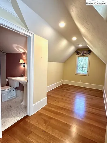 a view of a room with wooden floor and window