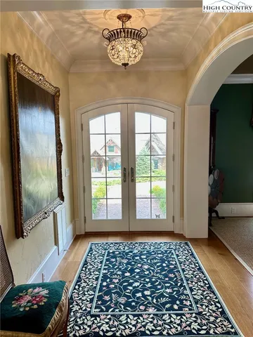 a view of a livingroom with wooden floor and a chandelier