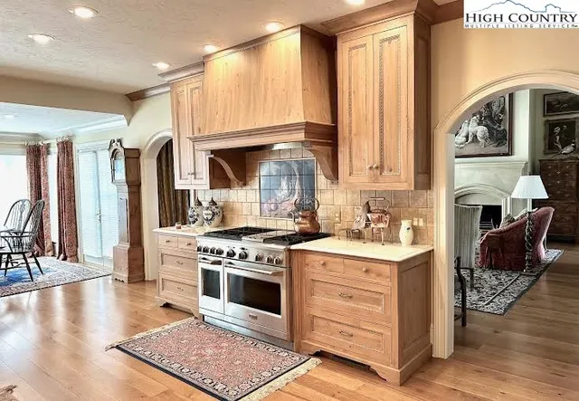 a kitchen with stainless steel appliances granite countertop a stove and a refrigerator