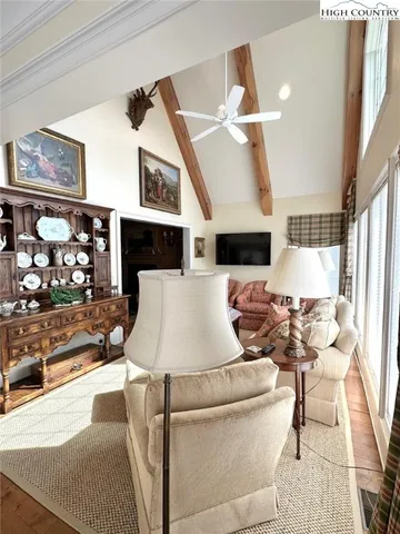 a living room with fireplace furniture and a lamp