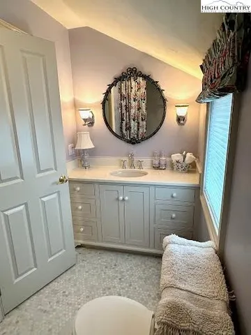 a bathroom with a sink a mirror and vanity