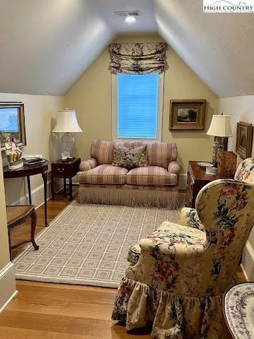 a living room with furniture and a lamp