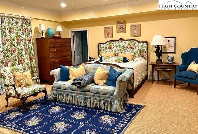 a bedroom with a bed couch and a window