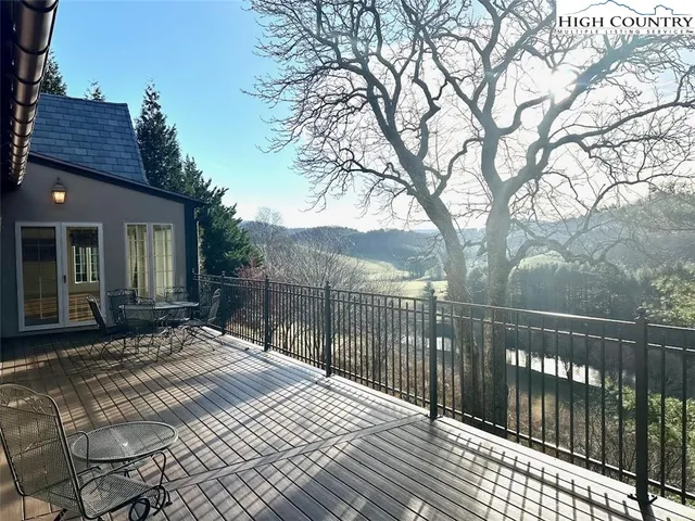 a view of a house with a wooden fence