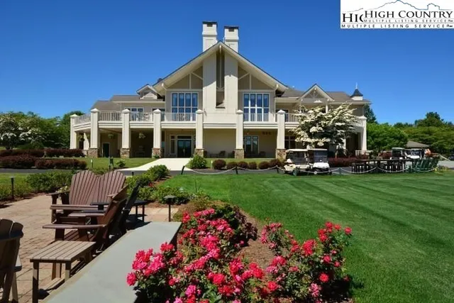 a front view of a house with a garden and sitting area