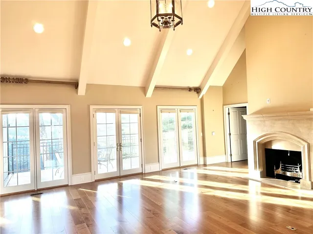 a view of an empty room with exposed radiator and fireplace
